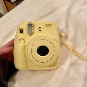 Instax Mini 8 yellow polaroid camera.